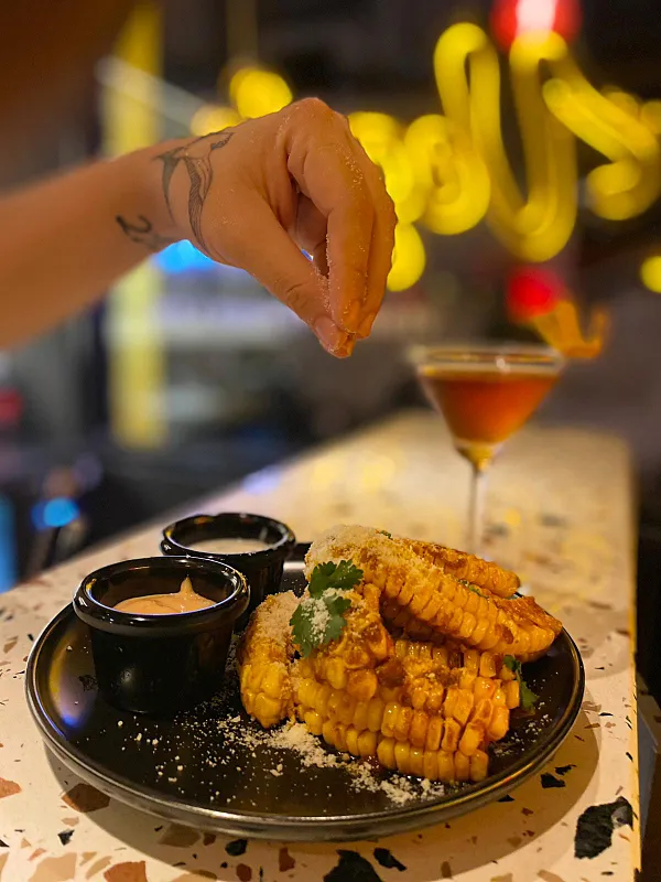 Finishing a plate of corn ready to be served for customers at the Veggie Junk vegetarian restaurant